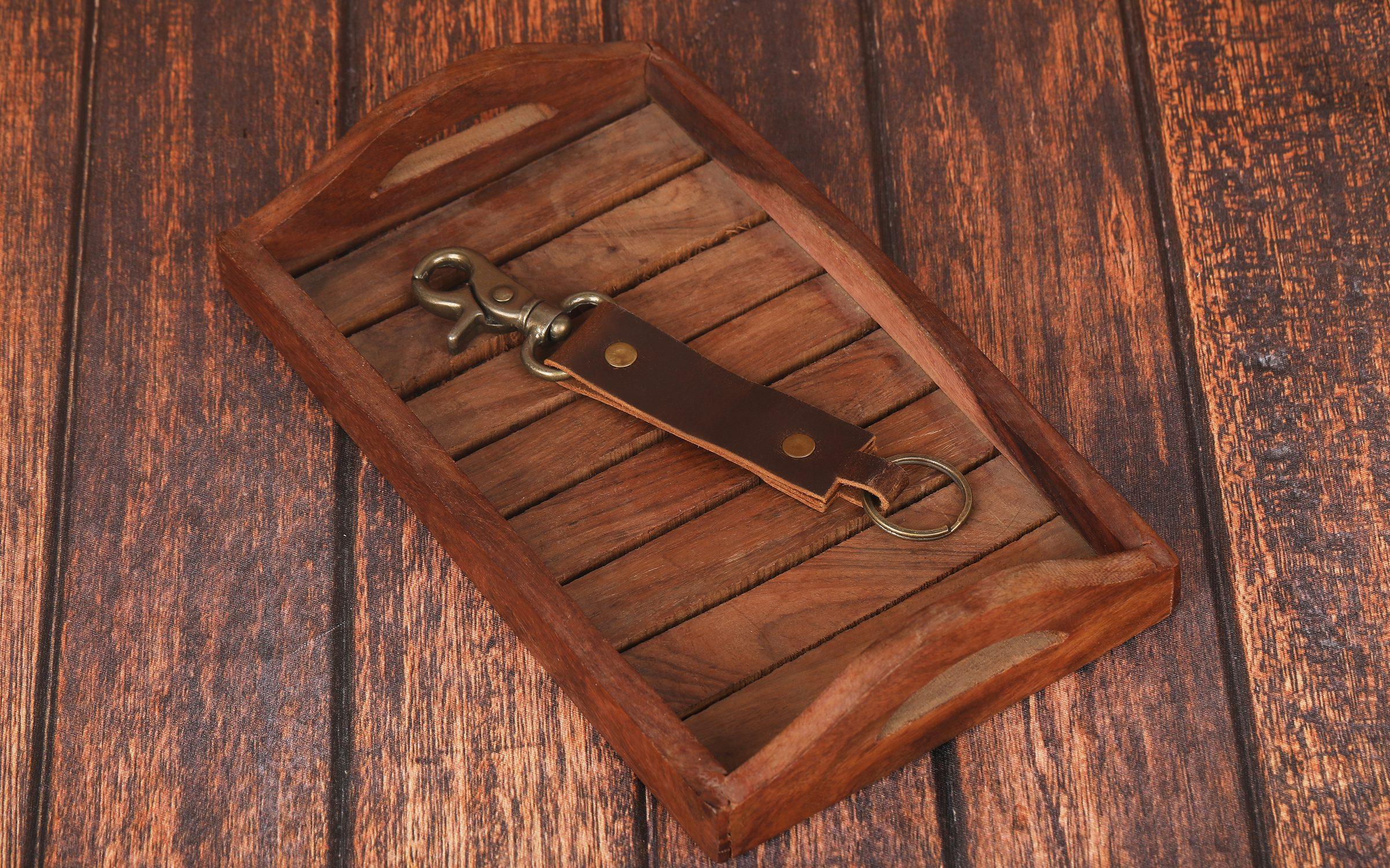 Hand-finished leather keyfob on a wooden tray — LokalKrafts craftsmanship